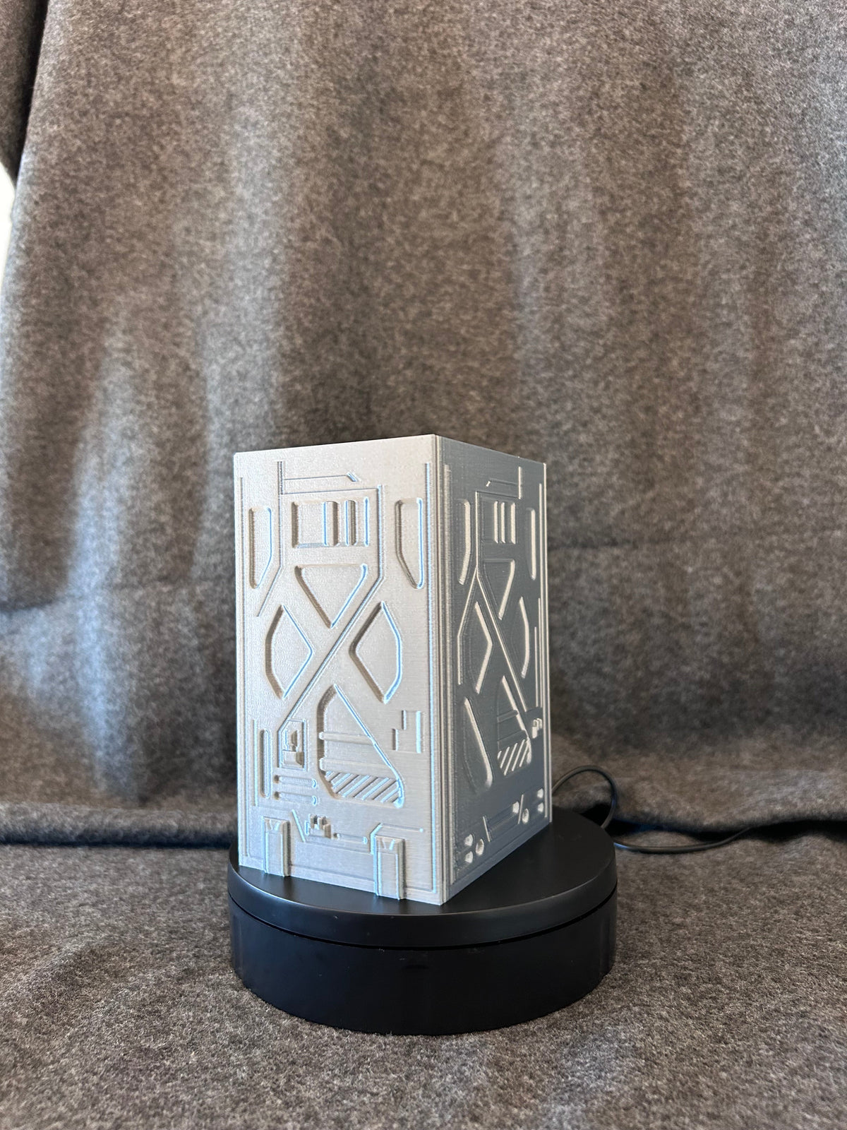 Close view of the recessed skull sigil and stencilled bays on the deck box face.
