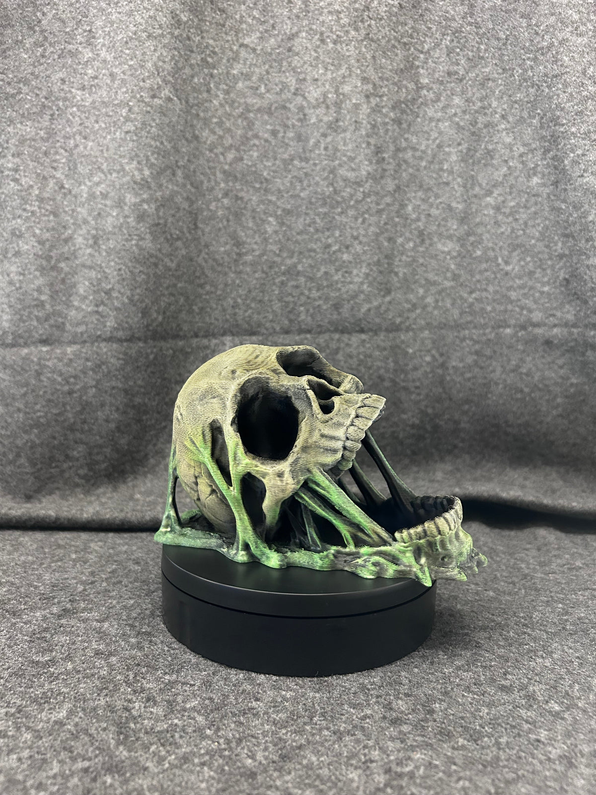 Side view of the skull dice tower showing the open jaw and the dice exit at the base.