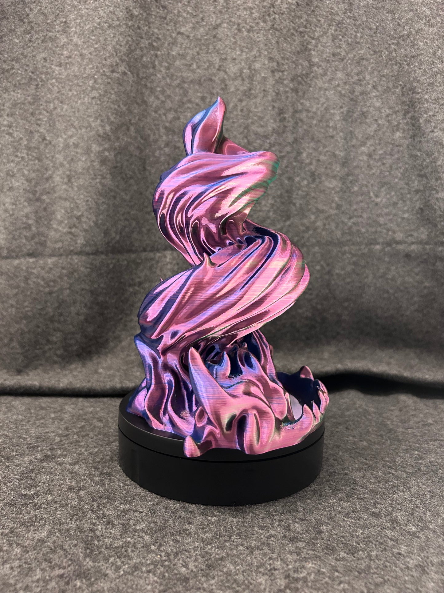 Close view of the layered ribbon form of the spiral dice tower.