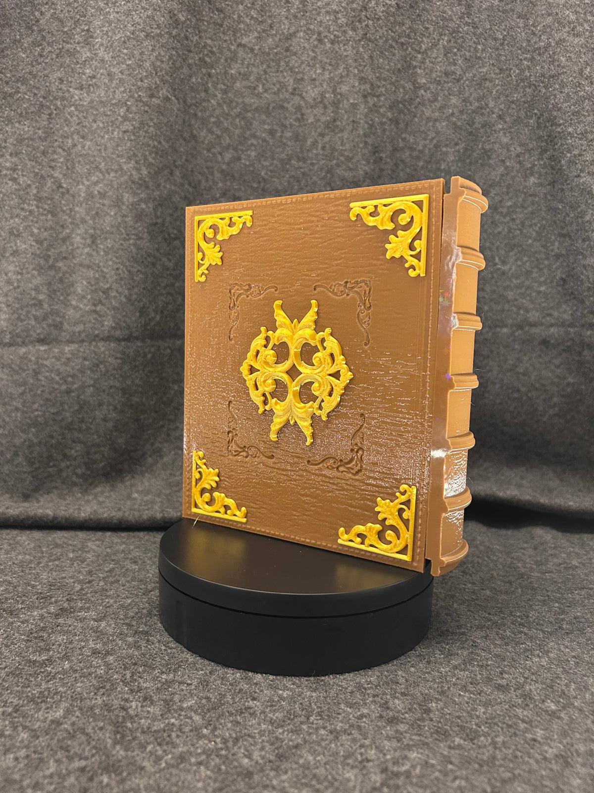 Close view of the gold tooling and painted parchment texture on the deck box.