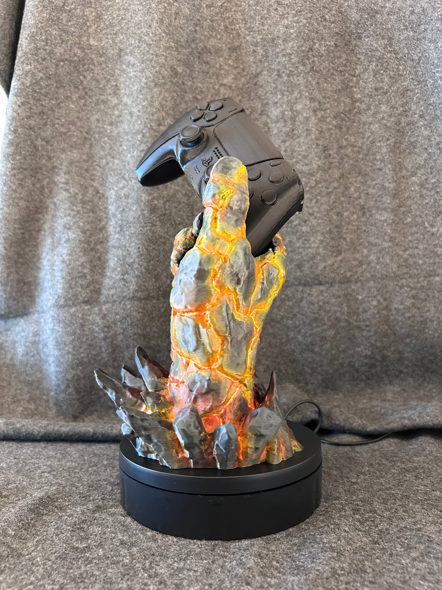 Side view of the magma hand controller stand showing the glowing fissures in the stone.