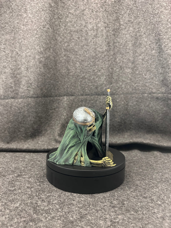 Hand-painted skeletal knight dice tower in deep green robes, gripping a two-handed greatsword, on a black display base.