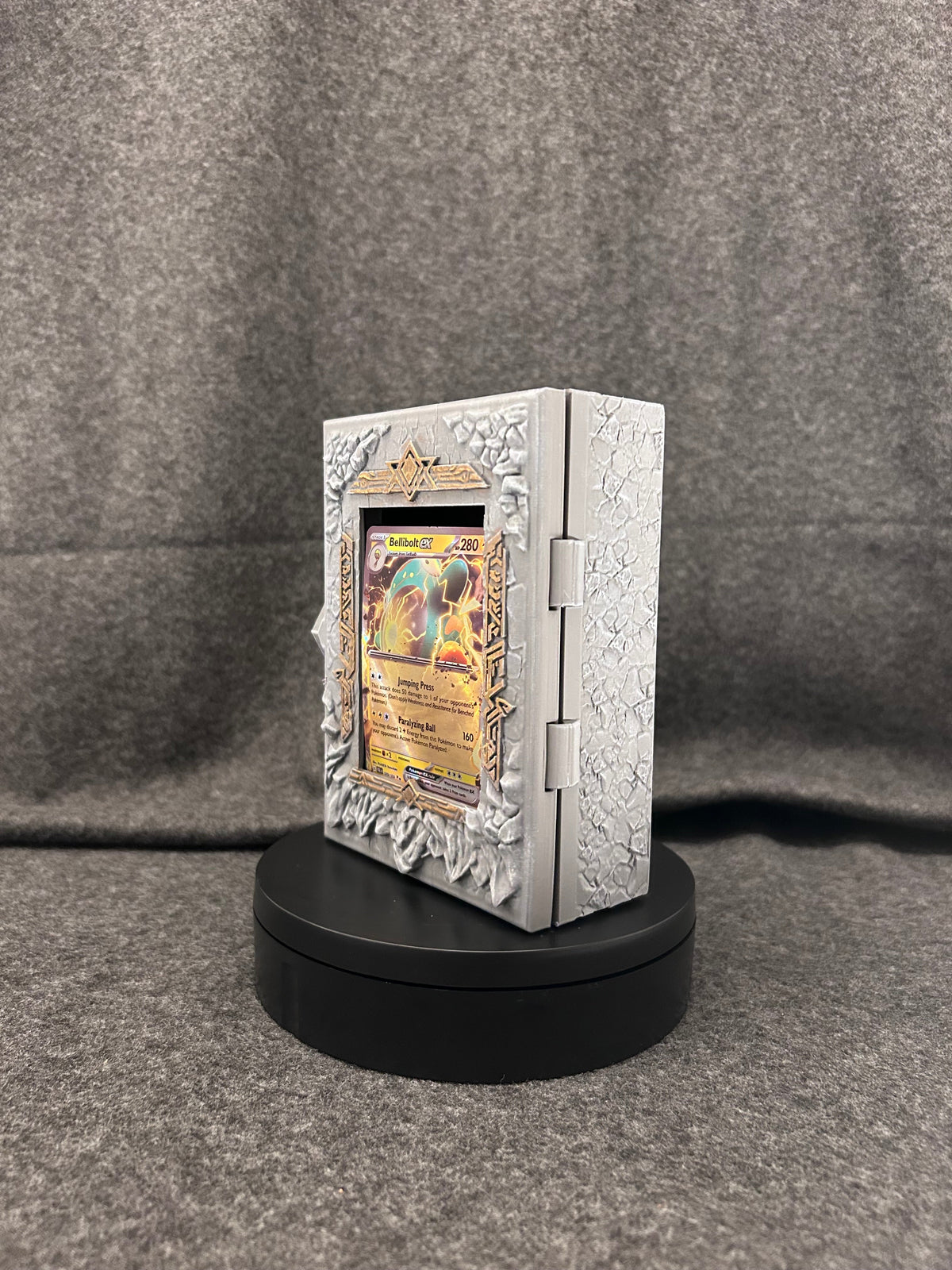 Side view of the Runestone Codex showing the hinge and the depth of the carved border.