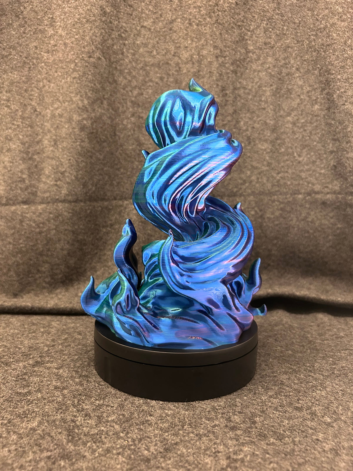 The spiral dice tower seen from another angle, the colour shifting from blue to violet.