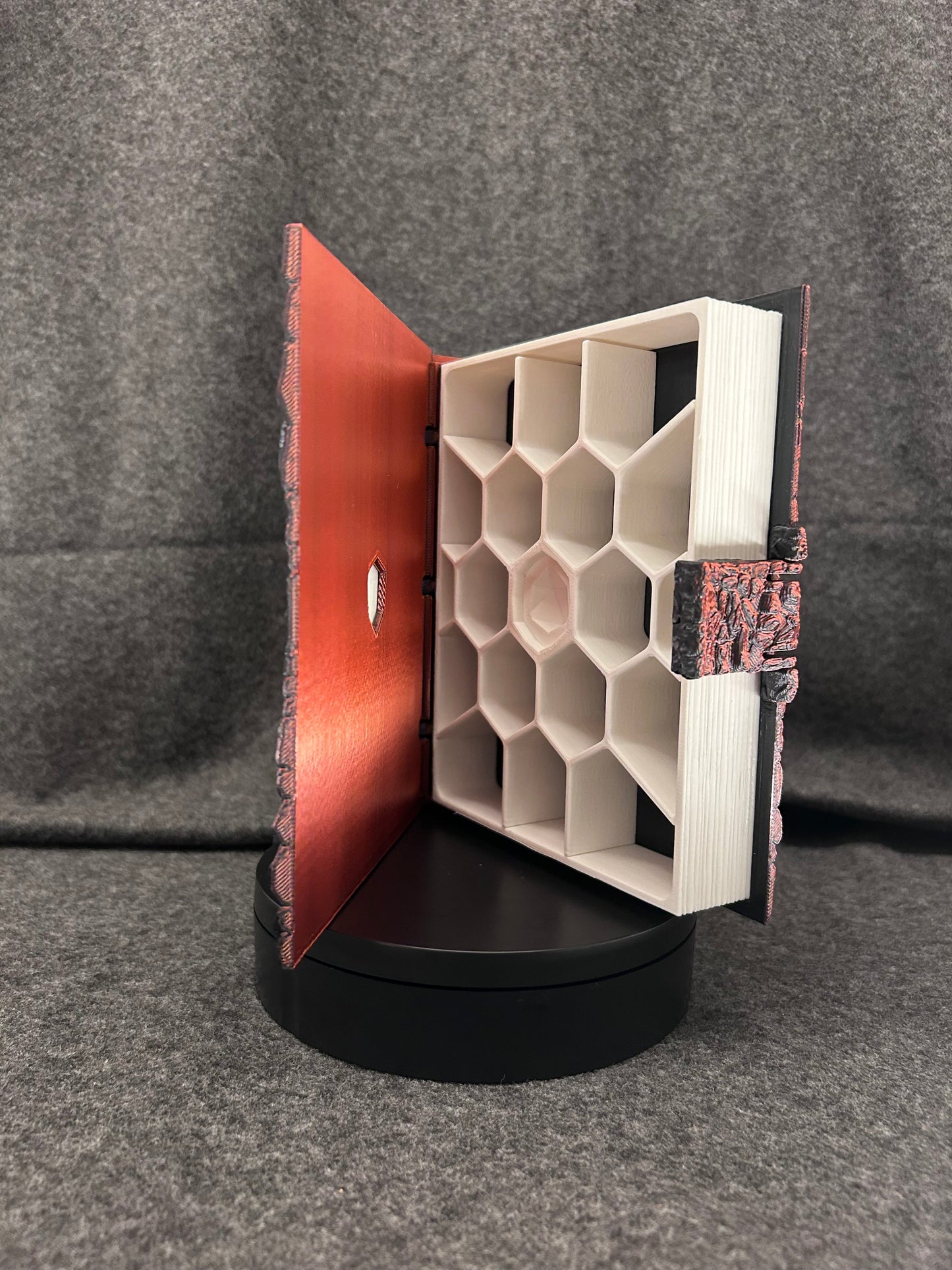 The same dice case painted in ember red, open to show the honeycomb tray.