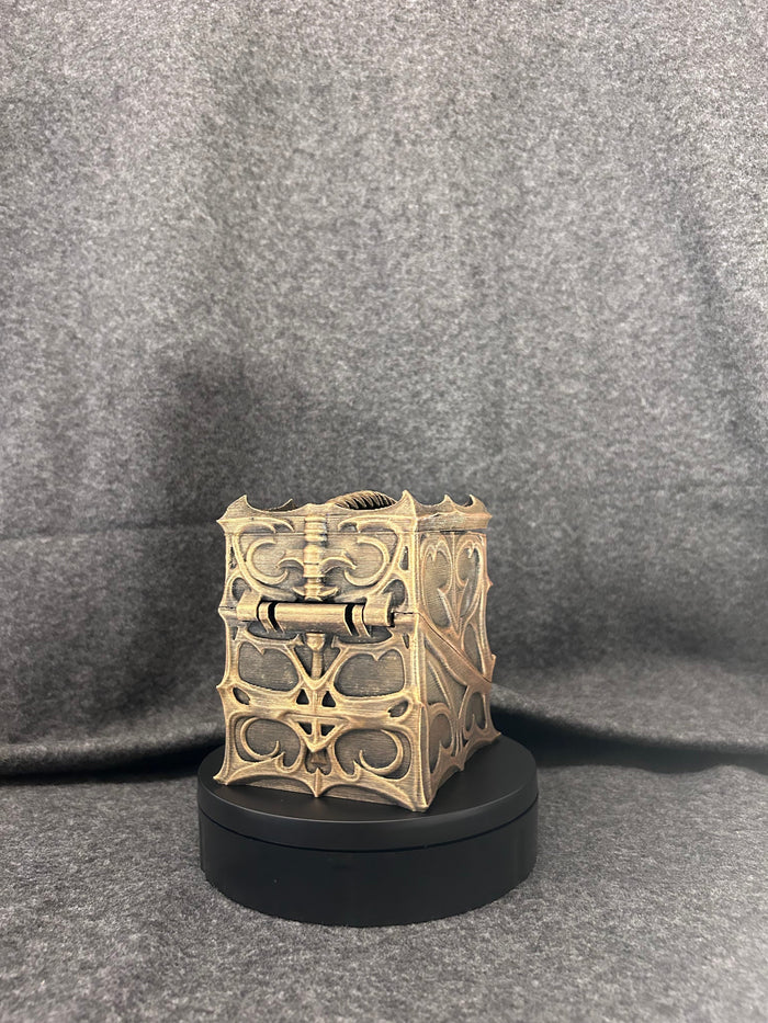 The Blackthorn Reliquary closed, showing pierced gothic tracery across every face.
