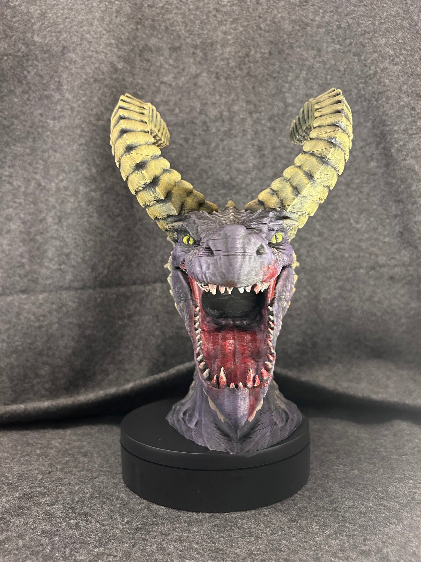 Front view of the Duskmaw dragon bust with jaws open, showing the teeth and red tongue.