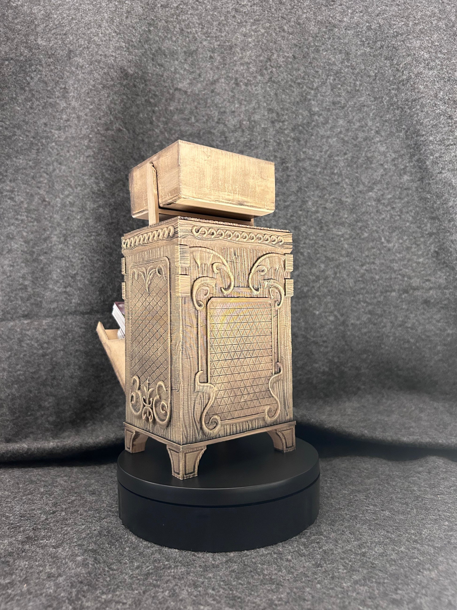 Front view of the deck chest showing the relief face worked into the panel.