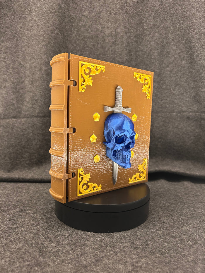 The Sworn Grimoire closed, showing the skull-and-sword emblem set into the cover.