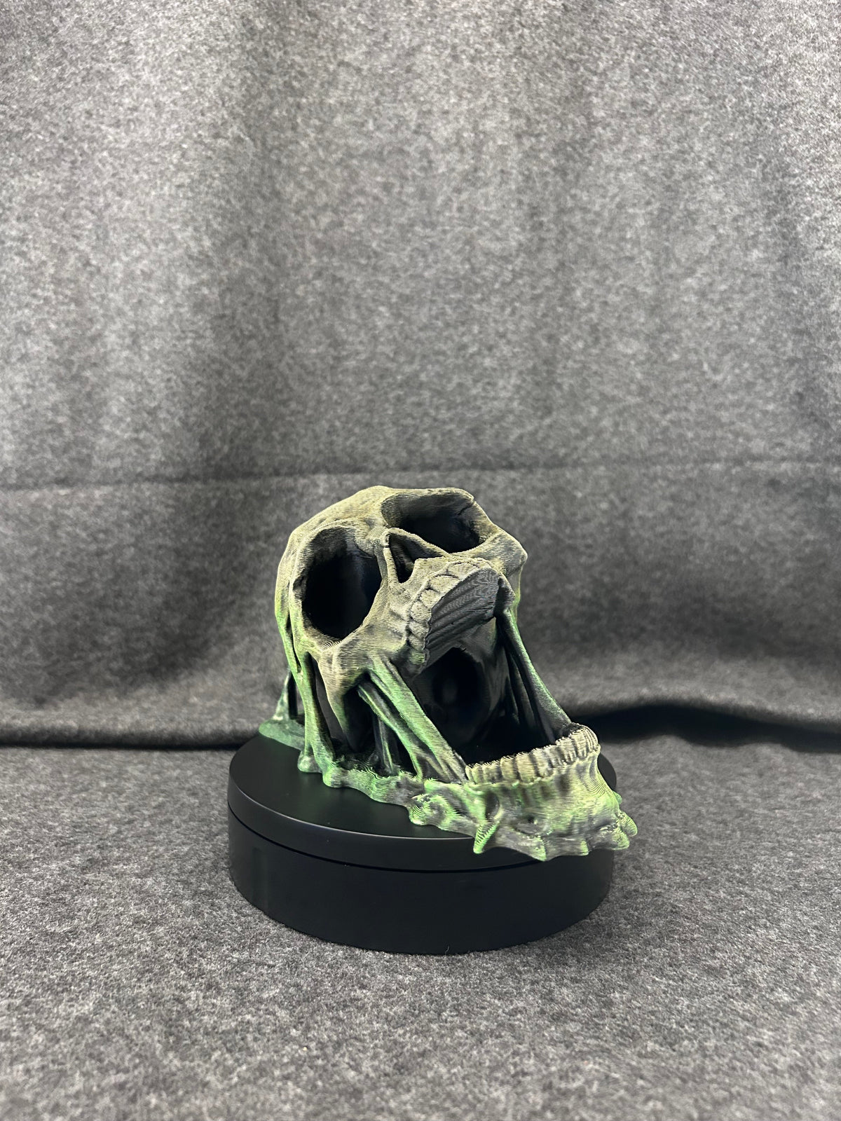 Close view of the skull dice tower's painted bone texture and green patina shading.