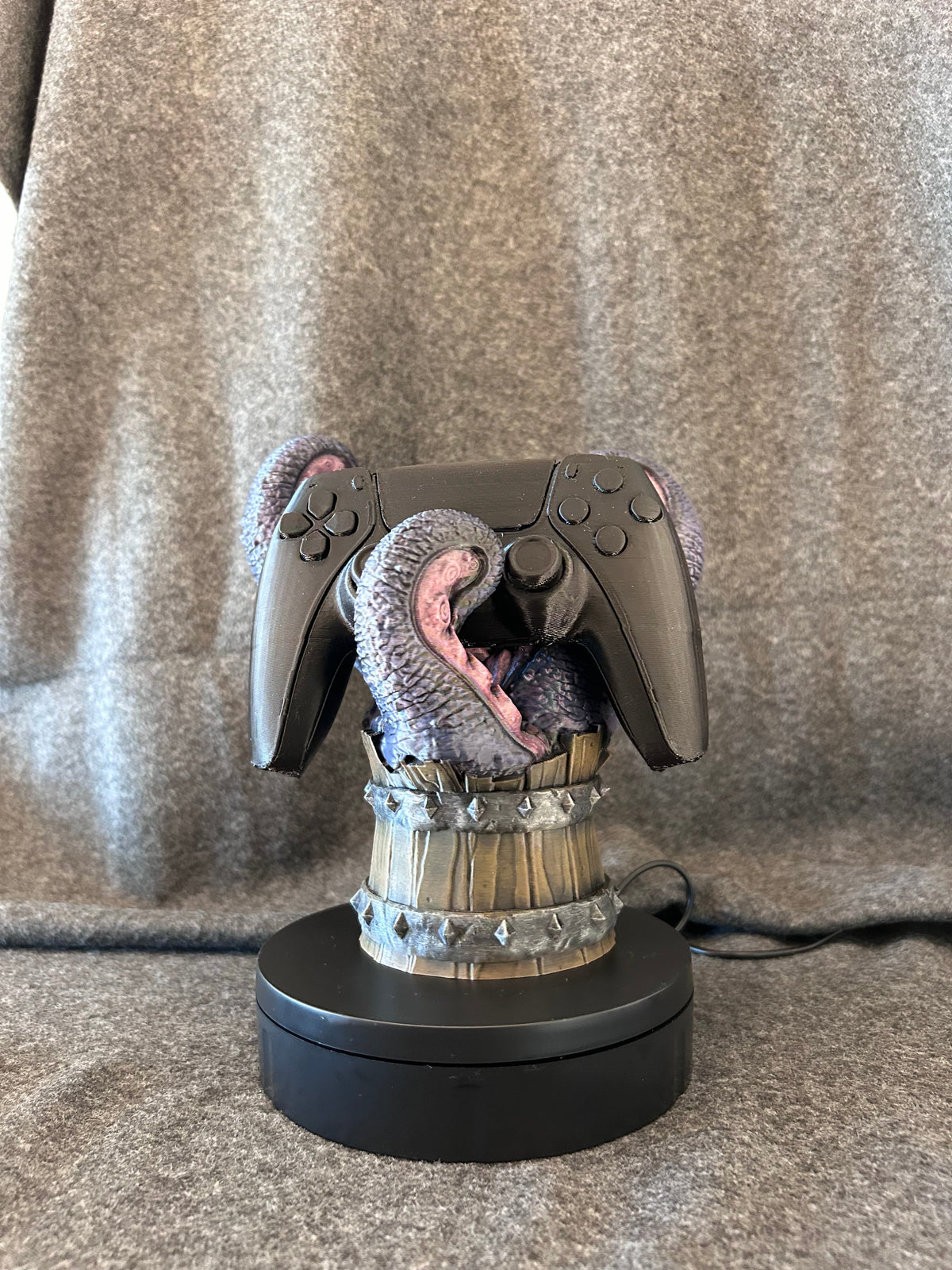 Hand-painted mimic tankard controller stand with tongues curled up to hold a controller.