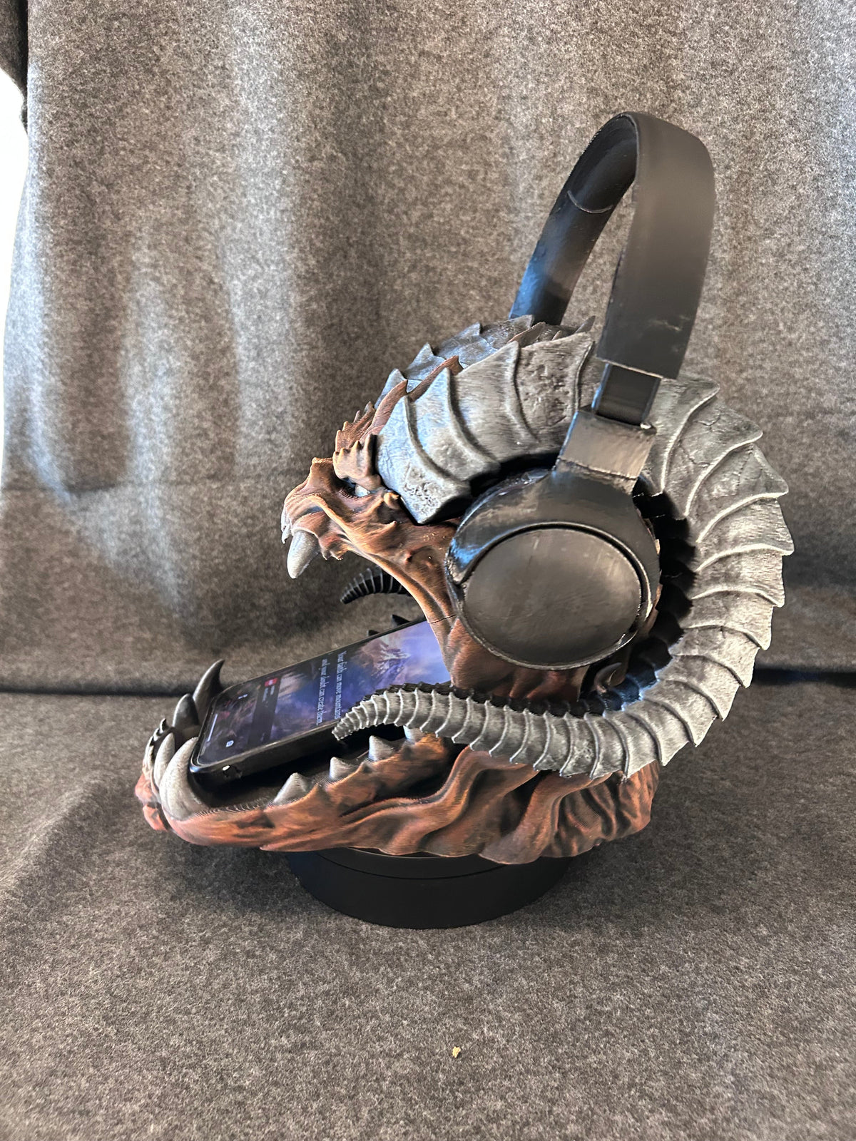 Side view of the dragon skull headphone stand showing the horn span and painted bone detail.