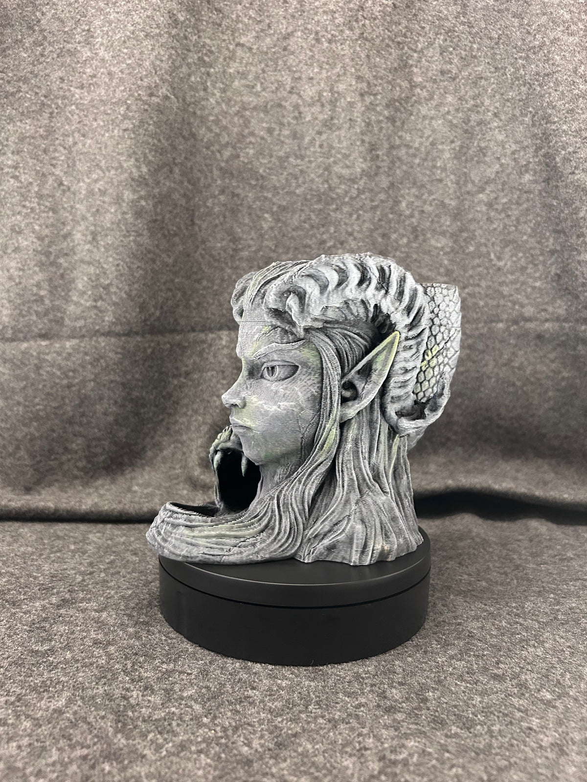 Hand-painted stone bust can holder, a woman's face with flowing hair and a coiled serpent at her shoulder.