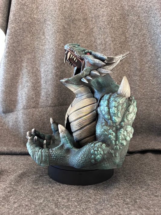 Hand-painted kinetic dragon dice tower in verdigris green, jaws open and front claws raised to take a dice set.