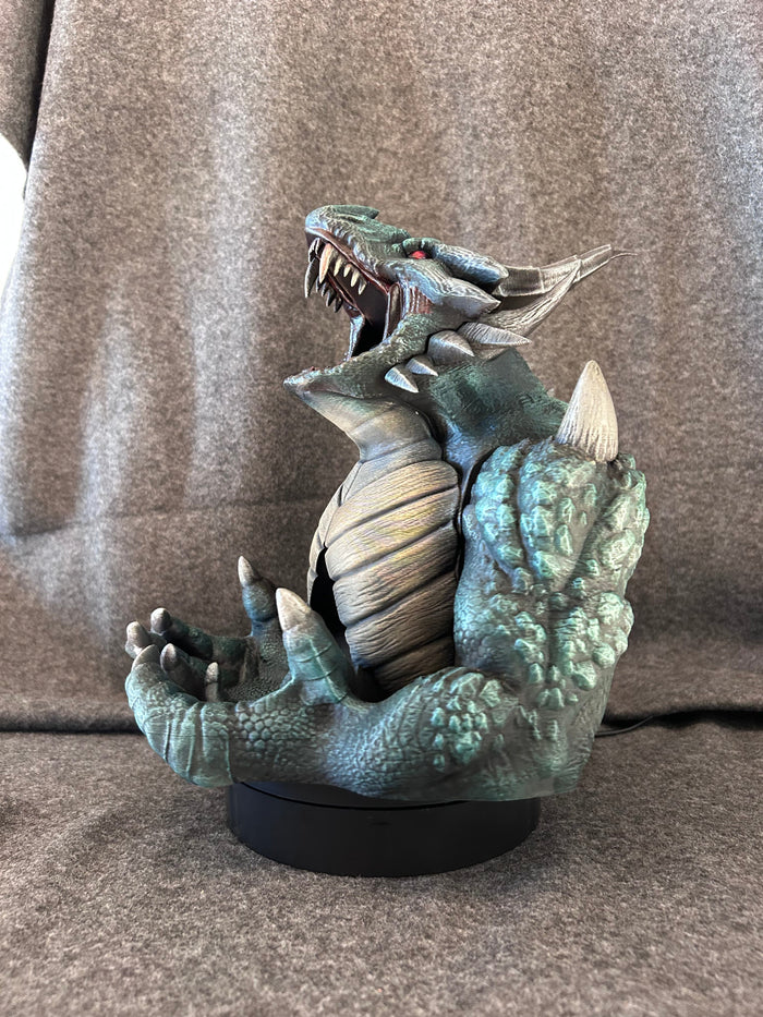 Hand-painted kinetic dragon dice tower in verdigris green, jaws open and front claws raised to take a dice set.
