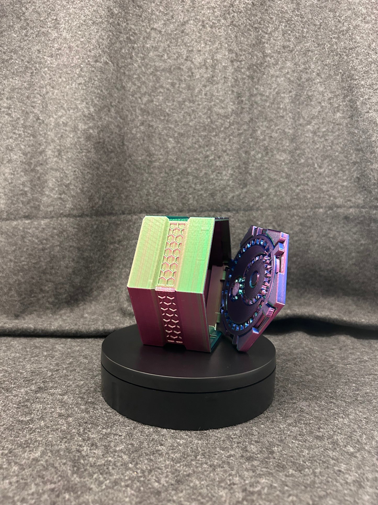 A dice box shaped like an oversized d20, split open to show room for a full dice set inside.