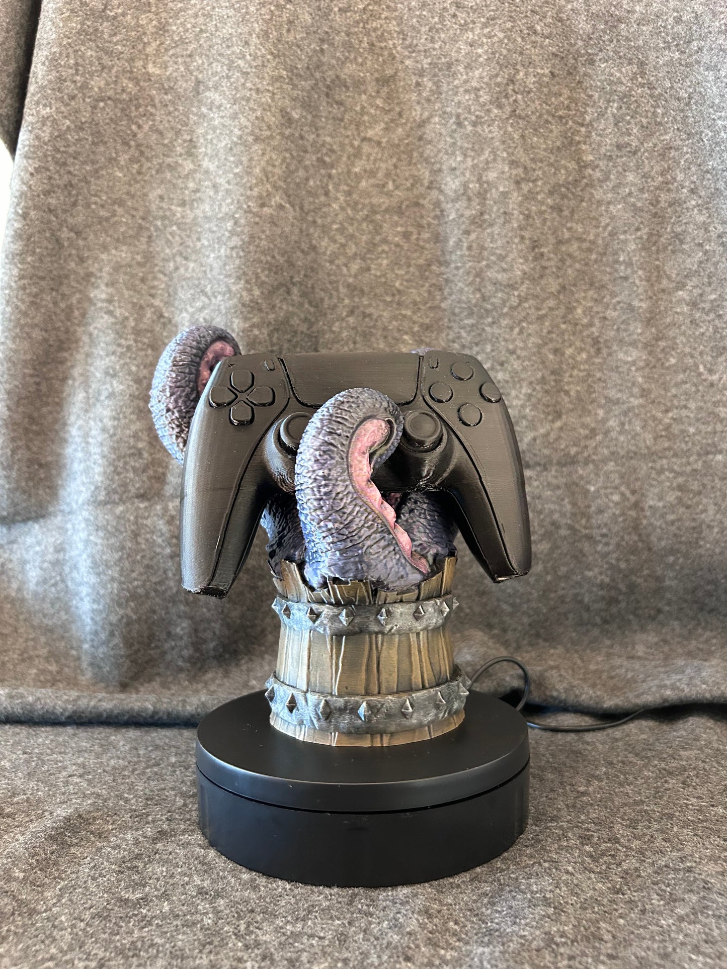 Close view of the painted tongues and fangs on the Mimic's Grip controller stand.