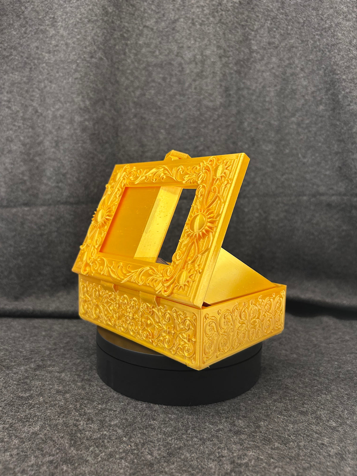 Side view of the Gilded Sun Codex showing the hinge and latch detail.