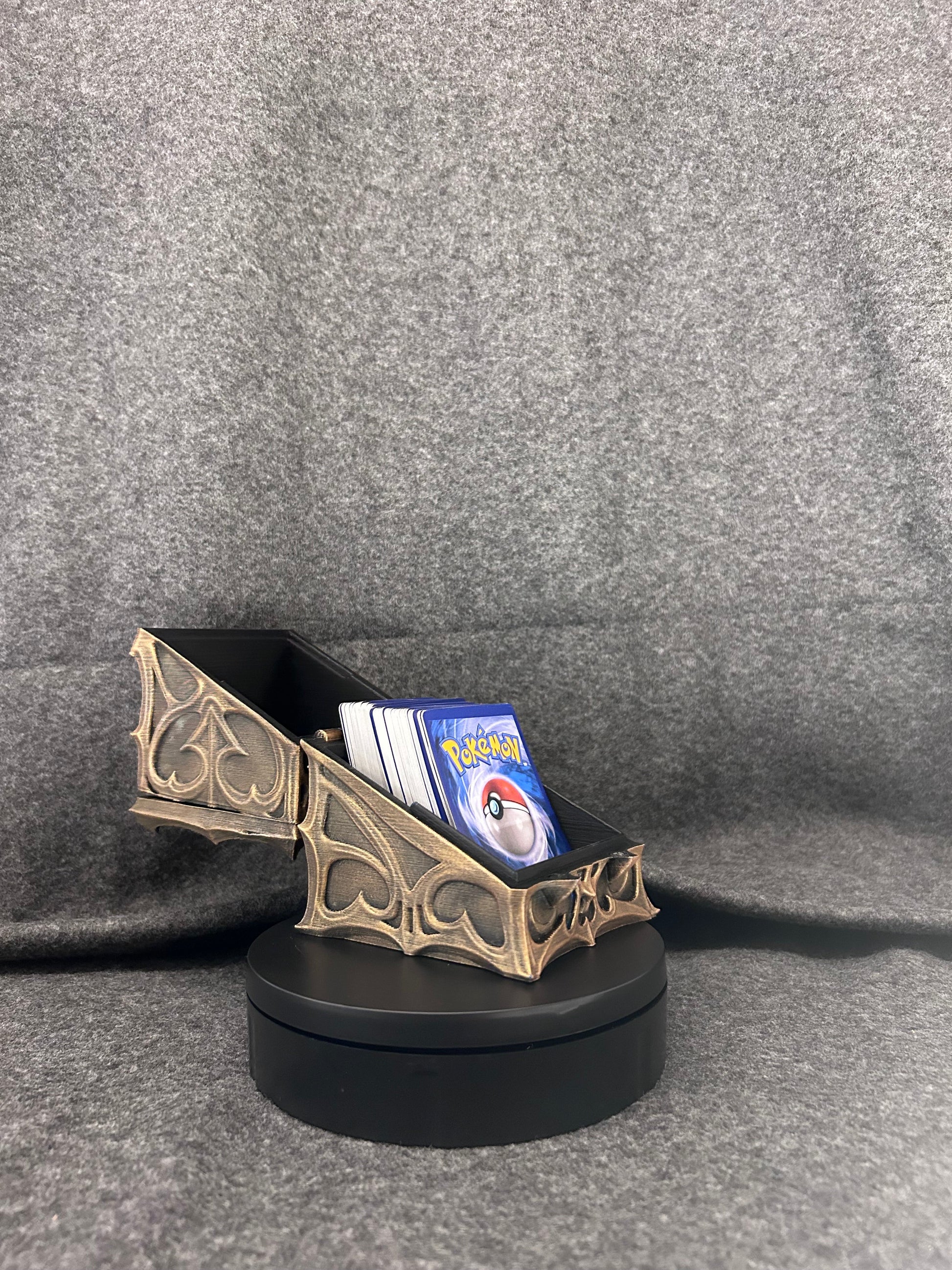 Hand-painted gothic deck box hinged open with a full stack of sleeved trading cards inside.
