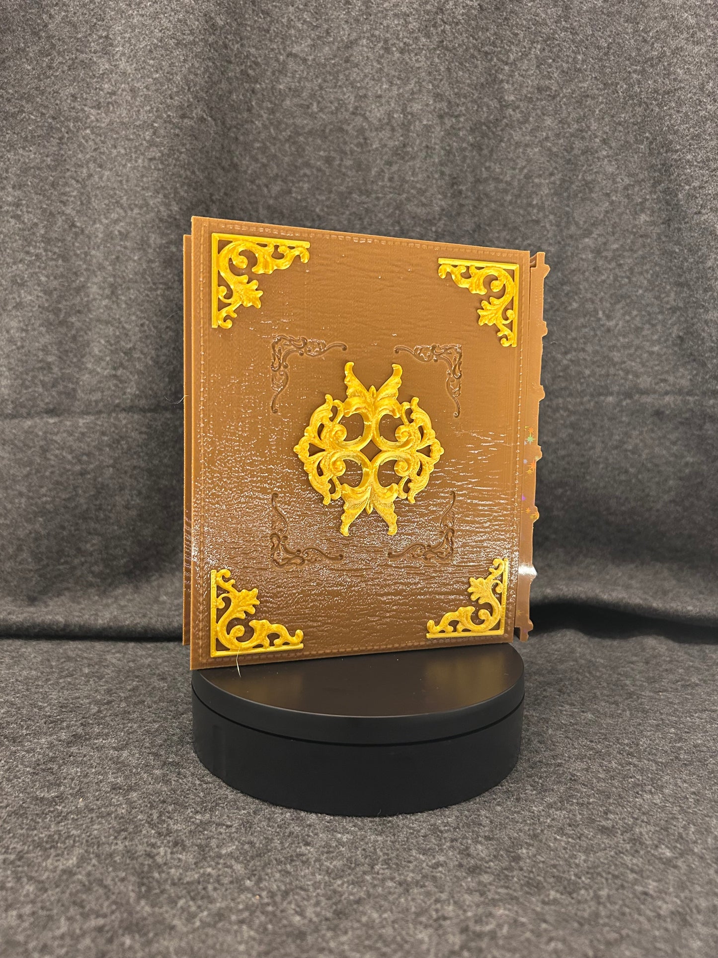 Side view of the Sworn Grimoire showing the gold-tooled spine.