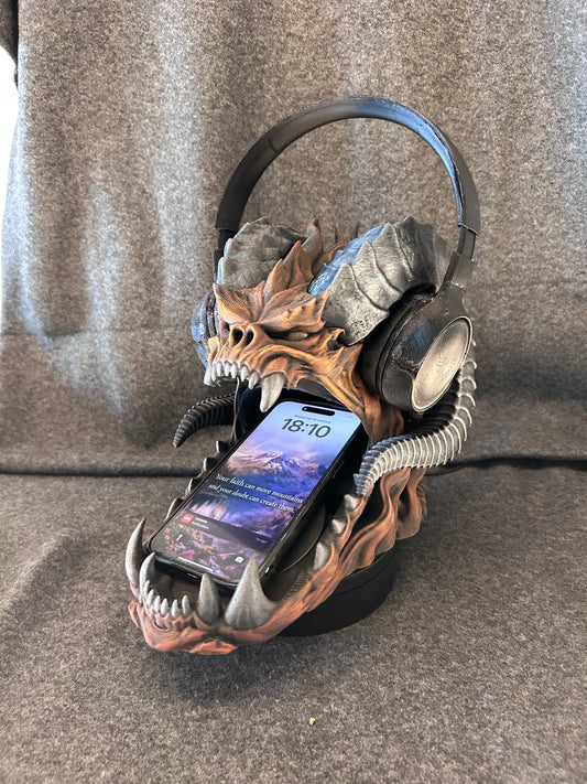 Hand-painted horned dragon skull headphone stand with an over-ear headset resting across its horns.