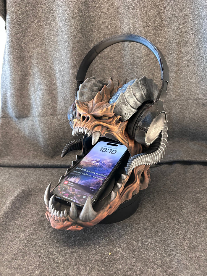 Hand-painted horned dragon skull headphone stand with an over-ear headset resting across its horns.