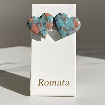 Heart-shaped earrings on a 'Romata' branded card