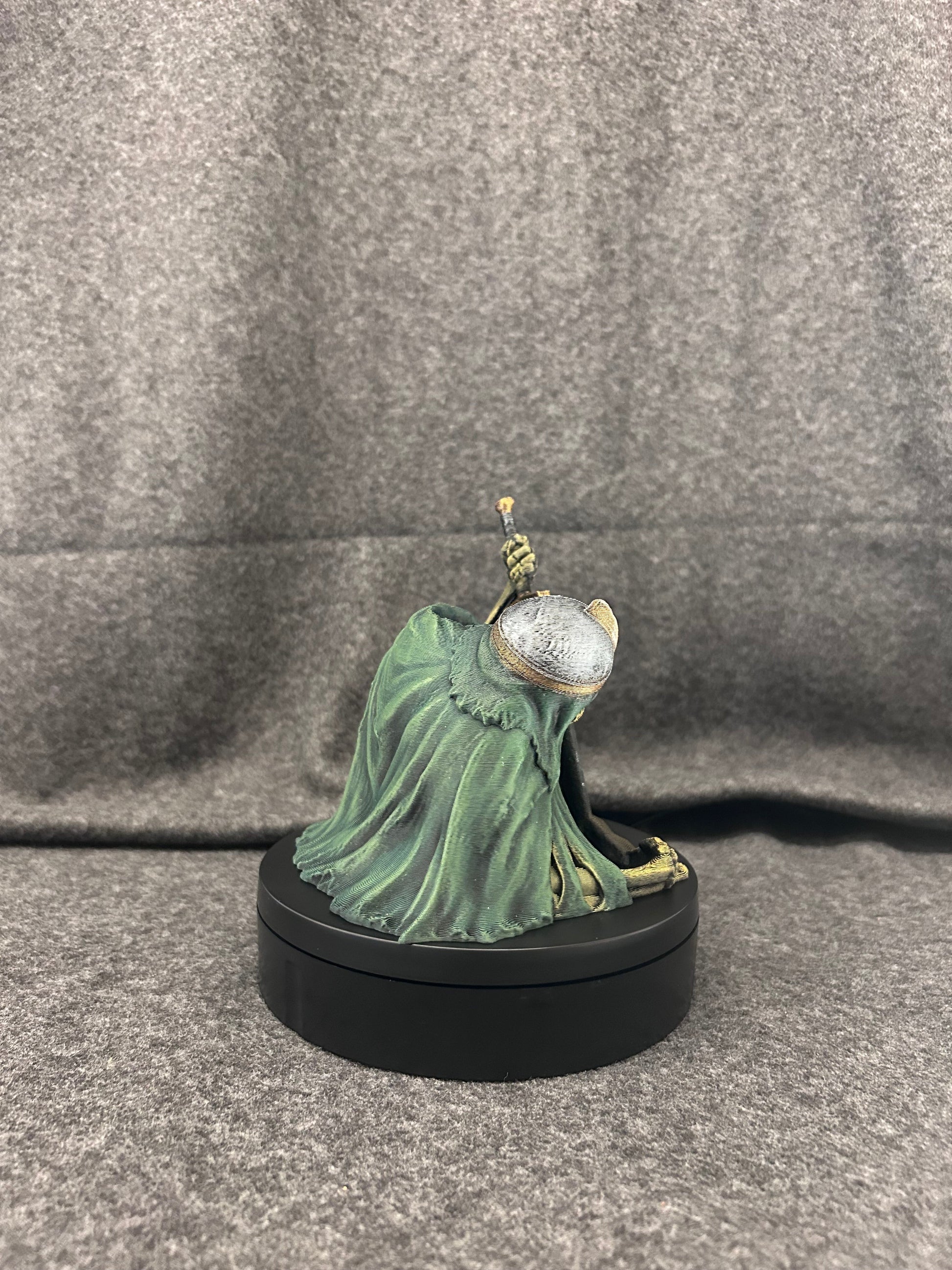 Close view of the skeletal knight dice tower's painted skull face and sword blade detail.