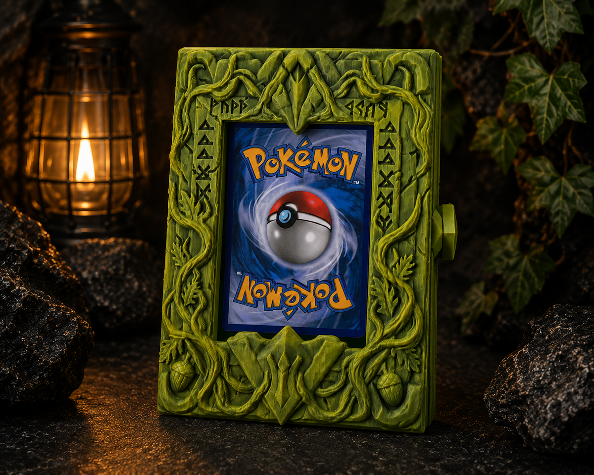 Green grimoire-style card display case carved with vines, acorns and runes, framing a single trading card, with a side latch.
