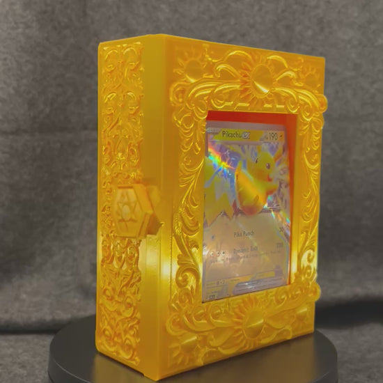 The Gilded Sun Codex turning on a display stand, showing the sun medallions and scrollwork.