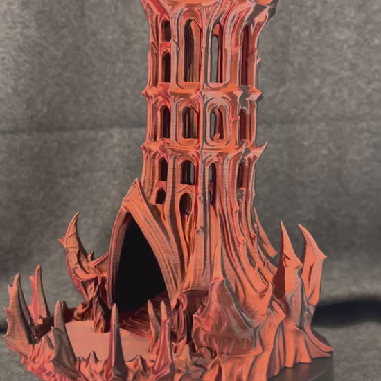 The Vespers gothic dice tower turning on a display stand, showing the pierced arch windows from every side.