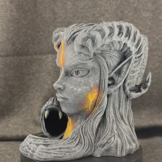 The Serpent Oracle turning on a display stand, showing the carved stone face and the coiled serpent.