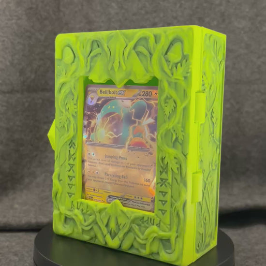 The Verdant Codex card display case turning on a display stand, showing the carved vine work.