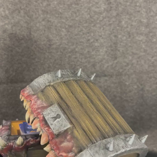 The Gnashwood mimic chest turning on a display stand, showing the fangs and lolling tongue.