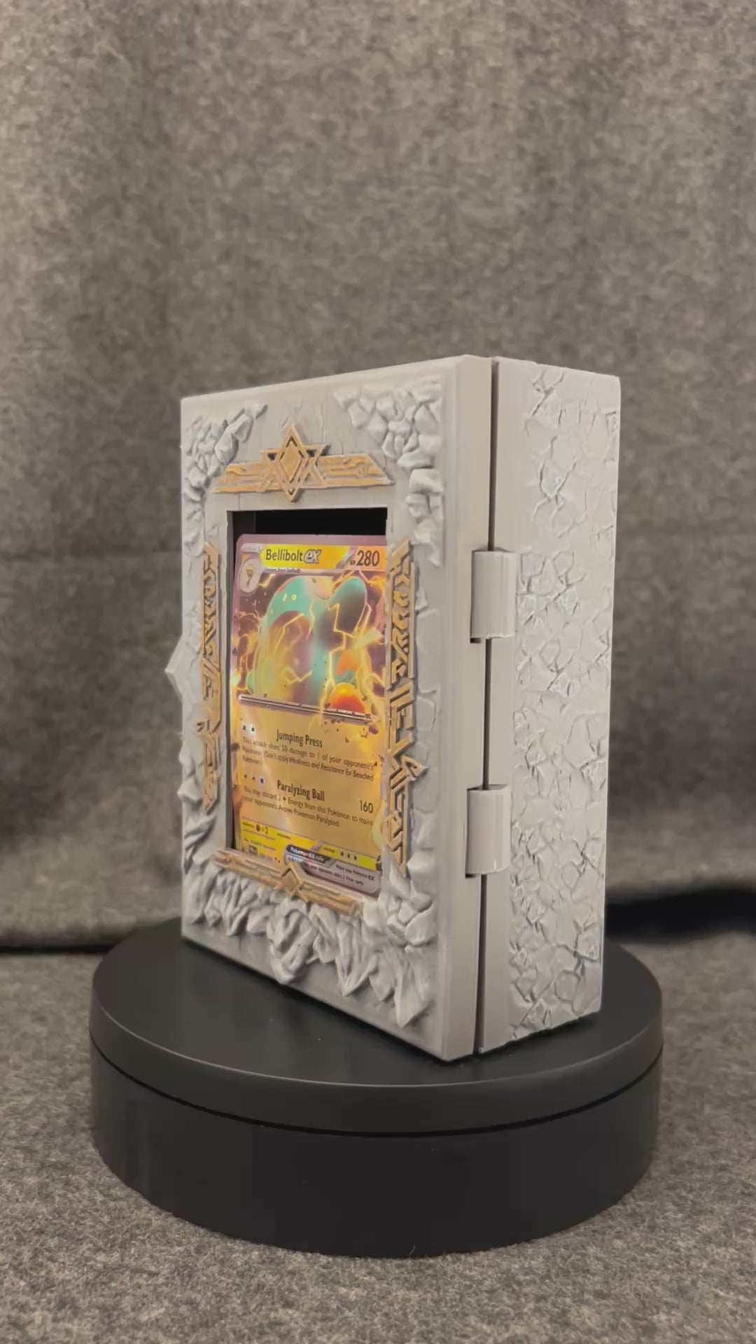 The Runestone Codex turning on a display stand, showing the carved rune band and gold-picked recesses.