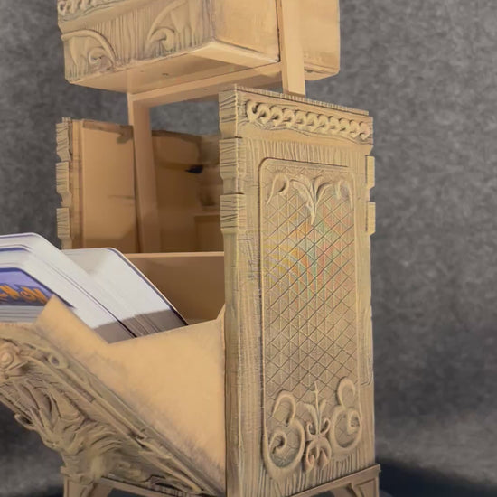 The Antiquarian deck chest turning on a display stand, showing the carved panels and lift-off lid.